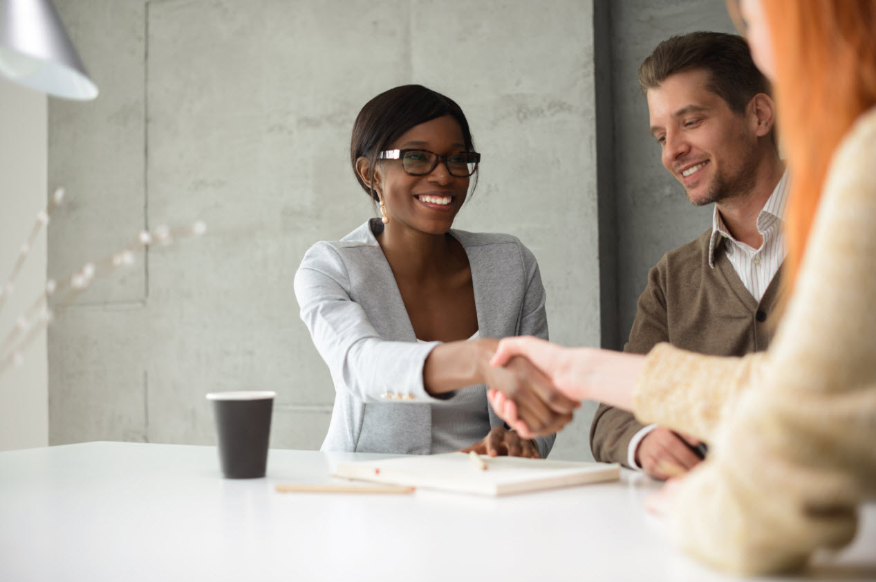 Sales woman shaking hands