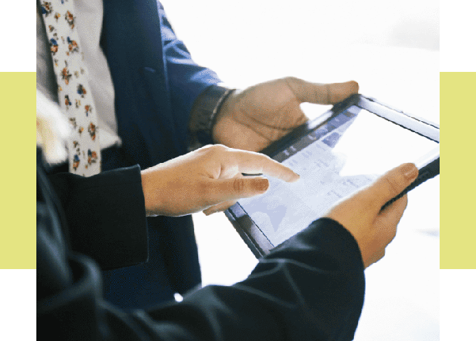 Image of two pairs of hands holding a tablet during a sales presentation.