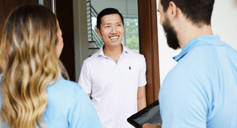 Image of two reps selling door-to-door to residential customers.